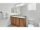 Bathroom with a wood vanity cabinet featuring double sinks and a large mirror above at 1920 E 145Th Ave, Thornton, CO 80602