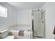 Bathroom featuring a built-in tiled tub and a separate glass-enclosed shower at 1920 E 145Th Ave, Thornton, CO 80602