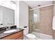 Bright bathroom featuring granite counters, a walk-in shower with glass door, and tiled shower at 1920 E 145Th Ave, Thornton, CO 80602
