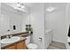 Bathroom features a large mirror, a vanity, and a washer and dryer at 1920 E 145Th Ave, Thornton, CO 80602