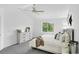Bright bedroom with a white ceiling fan, a window, and decor on top of the light wood dresser at 1920 E 145Th Ave, Thornton, CO 80602
