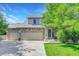 Charming two-story home with stone accents and a spacious three-car garage and manicured lawn at 1920 E 145Th Ave, Thornton, CO 80602