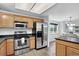 Well-equipped kitchen features stainless steel appliances and functional island with granite countertops at 1920 E 145Th Ave, Thornton, CO 80602