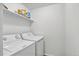 A compact laundry room with stacked washer and dryer provides efficient space utilization at 1920 E 145Th Ave, Thornton, CO 80602
