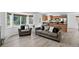 Comfortable living room features wood floors, neutral colors, and a large window with a backyard view at 1920 E 145Th Ave, Thornton, CO 80602