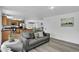 View of living room leading to a kitchen and dining area featuring updated flooring at 1920 E 145Th Ave, Thornton, CO 80602