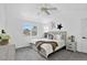 Main bedroom with vaulted ceilings, ceiling fan, and a large window looking out to the neighborhood at 1920 E 145Th Ave, Thornton, CO 80602