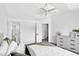 Spacious bedroom with ensuite bathroom features neutral colors, ceiling fan, and natural lighting at 1920 E 145Th Ave, Thornton, CO 80602
