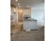 Bright kitchen with island and white cabinets awaiting final touches at 6679 Juniper Dr, Thornton, CO 80602