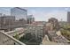Balcony view overlooking city with surrounding building and train tracks at 1700 Bassett St # 1008, Denver, CO 80202