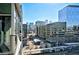 Balcony view featuring a vibrant cityscape with modern architecture and clear skies at 1700 Bassett St # 1008, Denver, CO 80202