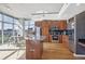 Modern kitchen with stainless steel appliances, a center island, and sleek dark cabinetry at 1700 Bassett St # 1008, Denver, CO 80202