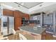 Granite island kitchen with stainless steel appliances and wood cabinets at 1700 Bassett St # 1008, Denver, CO 80202