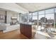 Open living area with hardwood floors and city views at 1700 Bassett St # 1008, Denver, CO 80202