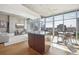 Open living space with modern furnishings, hardwood floors, and expansive windows with city views at 1700 Bassett St # 1008, Denver, CO 80202