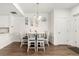 Cozy dining room with white chairs, wood floors, and decorative wall art for a modern look at 5744 Alton St, Denver, CO 80238