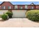 Attached two car garage with a wide driveway and mature landscaping that provides privacy at 5744 Alton St, Denver, CO 80238