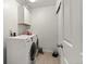 Functional laundry room with modern washer and dryer, built-in cabinets, and convenient storage space at 5744 Alton St, Denver, CO 80238