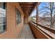 Brown exterior balcony with wood floor and railing at 4691 S Decatur St # 212, Englewood, CO 80110