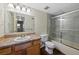 Well-lit bathroom with modern cabinets and a shower with glass doors at 4691 S Decatur St # 212, Englewood, CO 80110