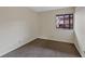 Small bedroom with gray carpet flooring and a window at 4691 S Decatur St # 212, Englewood, CO 80110