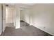 Bright bedroom with gray carpet and sliding closet doors at 4691 S Decatur St # 212, Englewood, CO 80110