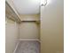 Walk-in closet with carpet flooring and built in shelving at 4691 S Decatur St # 212, Englewood, CO 80110