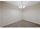 Carpeted dining room with traditional lighting fixture at 4691 S Decatur St # 212, Englewood, CO 80110