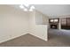 Carpeted dining room leading to living room with fireplace and outdoor balcony at 4691 S Decatur St # 212, Englewood, CO 80110