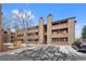Three story condo building features stone accents and private balconies at 4691 S Decatur St # 212, Englewood, CO 80110