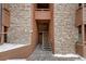 Apartment entryway featuring brick and wood exterior at 4691 S Decatur St # 212, Englewood, CO 80110