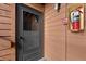 Apartment front door with glass window and fire safety equipment mounted nearby at 4691 S Decatur St # 212, Englewood, CO 80110