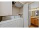 Laundry room with white washer and dryer next to the bathroom at 4691 S Decatur St # 212, Englewood, CO 80110