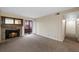 Living room with a stone fireplace and a sliding glass door leading to the balcony at 4691 S Decatur St # 212, Englewood, CO 80110