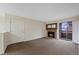 Living room with stone fireplace and sliding doors to an outdoor balcony at 4691 S Decatur St # 212, Englewood, CO 80110