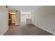 Open living area with carpet flooring leading to the kitchen and dining space at 4691 S Decatur St # 212, Englewood, CO 80110