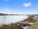 A picturesque pond on the property, complete with walking path, rocks, and partially frozen surface at 4691 S Decatur St # 212, Englewood, CO 80110