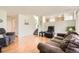 Open-concept living area with wood floors and staircase, seamlessly connecting to other living spaces at 9882 Harris St, Thornton, CO 80229