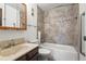 Updated bathroom featuring a tiled shower and tub, a vanity, and modern fixtures at 6505 Kalua Rd # 204B, Boulder, CO 80301