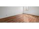 Bright bedroom featuring hardwood floors and a window for natural light at 6505 Kalua Rd # 204B, Boulder, CO 80301