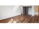 Bedroom featuring wood floors, closet with dark wood trim, and a view into the bathroom at 6505 Kalua Rd # 204B, Boulder, CO 80301