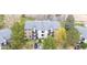Aerial shot of condominiums with landscaping and parking lot on a sunny day in a desirable location near a river at 6505 Kalua Rd # 204B, Boulder, CO 80301