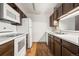 Well-maintained kitchen features white appliances, wooden cabinetry, and laminate countertops, creating an efficient and organized space at 6505 Kalua Rd # 204B, Boulder, CO 80301