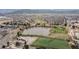 Aerial view of a neighborhood with a pond and soccer fields at 9620 W Chatfield Ave # D, Littleton, CO 80128