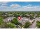 An aerial view of a neighborhood with tree-lined streets, houses, and a community park at 9620 W Chatfield Ave # D, Littleton, CO 80128