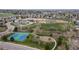 Aerial view of a school, tennis courts, playground, and a park at 9620 W Chatfield Ave # D, Littleton, CO 80128