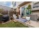 A cozy backyard with a seating area, patio, grill, potted plants, and string lights at 9620 W Chatfield Ave # D, Littleton, CO 80128