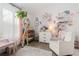 Bedroom featuring neutral carpet, large window, and decorative shelves, seat and decor at 9620 W Chatfield Ave # D, Littleton, CO 80128