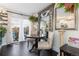 Elegant dining area bathed in natural light, showcasing stylish chairs and charming decor, with a door to outside at 9620 W Chatfield Ave # D, Littleton, CO 80128