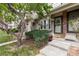 Inviting front porch with landscaped greenery and tasteful decorations, welcoming guests to the home at 9620 W Chatfield Ave # D, Littleton, CO 80128